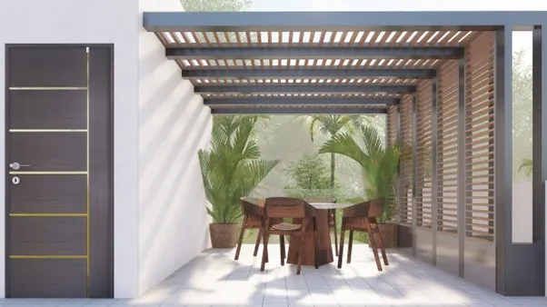 Spanish House Design showing a terrace seating area with pergola, wooden furniture, greenery, and shaded outdoor space