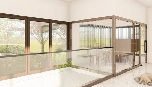 Spanish House Design showing a transparent home office with glass partitions, large windows, and natural light